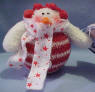 Candy Cane Snowman with red ear muffs and star scarf Christmas Ornament. It has a gift card which as To and From. The card also reads Gentle as snowflakes, Holiday Memories, drift into the heart and lead us home. 3 1/2 inches high