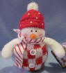 Candy Cane Snowman with striped scarf Christmas Ornament. It has a gift card which as To and From. The card also reads Gentle as snowflakes, Holiday Memories, drift into the heart and lead us home. 5 inches high