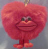 Gund Red Fuzzy Kiss A Moley Heart with Kissing Sound - This adorable fuzzy red heart has legs and ruby red satiny lips.  When you dangle it from the gold hanger, it makes a kissing sound. safe for all ages 5 1/2 inches