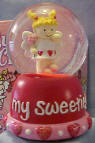 Gund Valentine's Day Musical Water Globes Angel Plays "Love Me Tender"  Comes boxed in a decorated gift box (see background of picture).  Small red hearts and glitter in globe.  On the base it reads "My Sweetie!"  Has hearts and beads around bottom of base.  She is holding a flower ready to give to her true LOVE! 3 inches