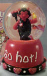 Gund Valentine's Day Musical Water Globes Little Devil Plays "Love Me Tender"  Comes boxed in a decorated gift box (see background of picture).  Small red hearts and glitter in globe.  On the base it reads "So Hot!"  Has hearts and beads around bottom of base.  He is holding a flame in one hand and pitchfork in the other. 3 inches high