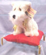 Holiday Snowflake the West Highland Terrier with Red Velvety Pillow with Gold Tassels. Snowflake has a Gold Lame' ribbon around the neck.  10 inches