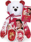 Front View of the Elvis 'Can't Help Falling In Love' Teddy Bear - (this is the 15th bear in the series) The Elvis Can't Help Falling In Love Bear has colorful images of Elvis. Both the front and the back of the bear are GREATLY detailed! The Bear wears a tag with information about the 'Can't Help Falling In Love': "The ballad, 'Can't Help Falling in Love,' is one of Elvis' classic hit songs. This single was featured in Elvis' 1961 film and album, Blue Hawaii. The lyrics were written by George David Weiss, Hugo E. Peretti, and Luigi Creatore. Originally performed by Elvis, numerous recording artists have also remade the song. 'Can't Help Falling in Love' continues to be one of the most romantic ballads of all time."