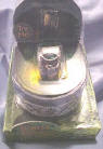 Aragorn - The Ring of Barahir The stone in the ring is a green marquee cut. The Emerald Stone is in an artistic design wide band with antique silver look there is gold melted onto it. It is in a Gorgeous Arch Shaped Resin Black Ring Box with Ornate Silver and Black Decorations. The Top of the Box has a Fanlike Mystical Symbol on it.