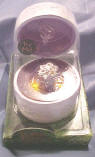 Galadriel - Nenya, the Ring of Water The ring is platinum color in a pearly white oval shape resin ring box. The box has an ornate duplicate design of the Ring, engraved on top of ring box.