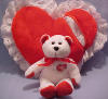 I Love Lucy Red Heart Pillow with Lace Trim and White and Red Teddy Bear - Bear is plump full of beans.  Bear comes zipped into a pouch in the back of the plump Pillow. dated 2001  pillow is 13 inches wide, 11 inches high and 4 inches thick Bear is 7 1/2 inches