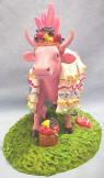 This adorable Cow is dressed like Lucy Ricardo was dressed in Episode 3 of the I Love Lucy Show. The cow is pink with white skirts with multi color trim. It wears a hat on its head with fruit in it. Episode # 3, entitled "Be A Pal" first aired on October 22, 1951. Lucy Ricardo wanted to keep the romance in her marriage alive, and began reading a book "How to Keep the Honeymoon from Ending." One of the suggestions was to re-create her husbands happy childhood experiences. Lucy dressed in a ruffled, south-of-the-border gown and did her best imitation of "Carmen Miranda" by dancing and singing the Brazilian Classic, "Mama Yo Quiero." Ricky could not help but to fall in love with Lucy again! It is limited in production to 3,500. 6 1/2 inches 7 1/4 inches long 5 inches wide high