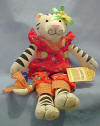 Country Cousins White Tiger - This adorable Country Cousins White and Black Tiger is dressed in a red pinafore jumpsuit with flowers and fruit decorating it. There are coordinating patches and buttons and a coordinating bow tied around the end of her tail. She has a yellow daisy with green ribbons on her head. 16 inches