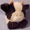 Puffkins Bean Bag Plush Meadow the Cow - DOB 3/13/97  (dark purple tag)  Meadow loves to pick daisies, enjoying the fields and being lazy.  Happy as happy can be, Meadow is the friendliest cow you'll ever see.  (introduced the Fall of 1997 and has been retired) 5 inches