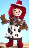 Applause Dakin Cowgirl Raggedy Ann Rag Doll - &nbsp;Raggedy Ann is all dressed up in her 'cowhide' black and white skirt and plaid shirt.  She wears a red cowgirl hat on her head with her bright red yarn hair sticking out from underneath. On her hands are brown gloves.  17 inches