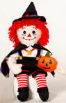 2003 Raggedy Andy Halloween Warlock with Pumpkin and Spider - special edition doll. Raggedy Andy has button eyes. Raggedy Andy wears black overalls with iridescent fabric star buttons and medallion, and a black suede cape with purple liner with glittering gold stars and gold trim. He also wears a pointed hat with a red ribbon band and purple spider, suede boots and holds a felt pumpkin. 16 inches