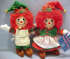 2002 Raggedy Ann and Andy Elf Ornament Set - Raggedy Ann wears a green corduroy top with plaid undershirt, red corduroy dress with white top apron, red corduroy hat and elf shoes. Raggedy Andy wears green corduroy pants, a red corduroy vest, plaid undershirt, green corduroy elf hat, apron with pockets and elf shoes. Each has a fabric loop on the back to hang it with. Both Rag Dolls have embroidered eyes and facial features. 6 inches each