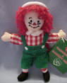 2003 Raggedy Andy Ornament / Package Decoration - Andy is wearing green corduroys with suspenders, a red and white checkered shirt, and a white hat. 5 inches high