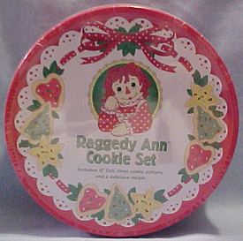 2003 Raggedy Ann Christmas Cookie Set Includes 6" Doll, three cookie cutters (tree, star, and heart), and a delicious recipe in a collectible Tin! 6 inch diameter tin