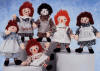 As Time Goes By Collector Box Set of 6 Raggedy Ann Dolls - Limited Edition of 7,500 sets. Each Doll in the set is numbered. P. F. Volland Co., 1918-1934: Cartoonist Johnny Gruelle patented his famous rag doll in 1915, but it was not until three years later that the P. F. Volland Company introduced the first commercially produced Raggedy Ann. Each charmingly primitive doll had shoe-button eyes and a "candy" heart stuffed inside her soft body (the hearts were really cardboard). Exposition Doll & Toy Mfg. Co., 1935: Gruelle's next doll licensee was the Exposition Doll & Toy Mfg. Company, whose Raggedy Ann had printed pie-cut eyes with no eyebrows or eyelashes. Her hair had a burgundy tint, and she wore felt shoes. The Exposition doll was the only commercially made Raggedy Ann without a heart. This rare doll was produced for less than one year. Molly-E's Doll Outfitters, 1934-1937: Exposition's short term as a manufacturer of Raggedy Ann was due to unfair competition from unauthorized dolls by Molly-E's Doll Outfitters. The attractive Molly-E's Raggedy Ann had printed eyes that glanced to one side, multicolored stripes on her legs, and distinctive blue shoes. She was the very first to have a heart, solid red, printed on her chest. Georgene Novelties, Inc., 1938-1962: Next came Georgene Novelties, who restored button eyes to the doll. This was the first company to add the words "I Love You" to Raggedy Ann's printed heart. During the years that Georgene made Raggedy Ann, the doll's face changed often, but her heart remained constant. Knickerbocker Toy Company, 1963-1982: Perhaps the best known manufacturer of Raggedy Ann was Knickerbocker: Their doll had a simple geometric face, with an appealingly direct smile. The pocket that is found on every Knickerbocker doll's apron shows the company's attention to detail. Applause and Dakin, 1980-2004: Applause began making Raggedy Ann dolls in 1980, and continued this tradition until 2004. Many handcrafted Raggedy Anns have embroidered faces, but Applause was the first commercial maker to add this quality feature to many of their dolls. In 1999, Raggedy Ann became part of the Dakin Signature collection which continued to proudly create many styles of Raggedy Ann & Andy Dolls. Each doll is 10 inches