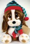 Christmas Musical Plush Sad Sam Basset Hound Caroler in Hat - Plays 'Silent Night' and 'We Wish You a Merry Christmas' when foot is pushed.  Sam is wearing a red, green, and blue gray stocking cap and matching neck scarf.&nbsp; 13 inches high