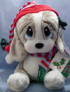 Christmas Musical Plush Sad Sam's Honey Basset Hound Caroler in Hat - Plays 'Silent Night' and 'We Wish You a Merry Christmas' when foot is pushed.  Honey is wearing a red and blue gray stocking cap and matching neck scarf.  She has evergreen color velvety bows on her ears. 13 inches high