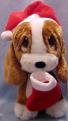 Christmas Sad Sam Santa Elf Basset Hound with Stocking - Sam is wearing a red velvety Santa hat with white faux fur trim.  He is holding a matching stocking which can be filled with goodies. (safe for ages over 3) 9 inches high