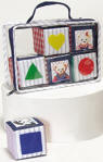 Blue Jean Teddy's Blocks in Carrying Case - There are 6 cubes 2.5" per side in a matching blue jean trimmed vinyl zippered carrying case. 2 of the blocks squeak, 2 of the blocks krinkle, 1 block has a rattle inside, and 1 block has a bell inside. Each block has a picture of an animal on one side and 2 of the sides have different shapes on them. The shapes are hearts, stars, squares, trianges, and circles. The shapes are in various colors and the blocks are in various colors too. The blocks are soft plush which make them easy for small hands to grab and also will not be harmful if you have a future star pitcher on your hands! Safe for ages 18 months +