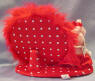 Back view of Gund Olivia Pig Dresser Mirror&nbsp;- Olivia is holding a tube of lipstick in her hand with lipstick on her lips. She has a red satiny bow around her ears which matches her red satiny evening dress with white pearly looking necklace and bracelet on. On Olivia's feet are red satiny dress shoes. She is fully dressed for an evening out on the town! The mirror is actually bigger than it appears in the picture. (For the picture the mirror was tilted down to not get a reflection from the flash.) Surrounding the mirror is fluffy red feather material.   Olivia Pig can be removed from the base with a snip of the threads. Her dress is also removable.  9 inch base 7 inch mirror 8 inch Olivia