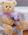 Gund Teddy Bear with Lilac Flower Bouquet  The Teddy Bear is made from a ultra soft plush material. The flowers are velvety soft and arranged with netting and matching bow.  13 inches
