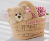 Gund Teddy Bear in Basket with Flowers the side of the basket reads I LOVE YOU MOM safe for children.  basket is 5 inches wide 2 1/2 inches deep with a 2 1/2 inch handle Bear is 3 inches