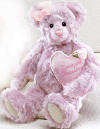 Gund Purple Grandma Teddy Bear with Pink Heart Pillow - In Grandma bears arm is a pink  heart pillow with  LOVE YOU GRANDMA embroidered on the front. Teddy Bear is super silky soft.  safe for children 12 inches