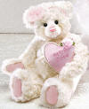 Gund Cream Teddy Bear with Pink Heart Pillow  In the bears arm is a pink heart pillow with  LOVE YOU embroidered on the front. Teddy Bear is super silky soft.  safe for children 12 inches high