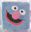 Gund Sesame Street Plush Block with Cookie Monster, Oscar the Grouch, Elmo, Zoe, Grover and Big Bird on each of the sides - each face is on a side of the block.    11 1/2 inch cube
