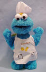 Gund Sesame Street Plush Chef Cookie Monster - made from a soft plush fabric Cookie Monster is made.  He looks adorable in his chef's hat and apron a great way to promote imagination! 8 inches high