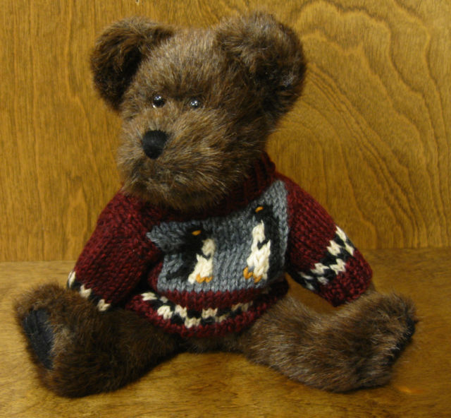Boyds Teddy Bear Wayfer North Boyds Teddy Bear Wayfer North
- introduced Fall 1999 and has been retired
- Wayfer is in his burgundy handknit pullover with a black-and-white checkered border and penguin portrait motif, he's stylin' from here to the Pole. An adorable mocha colored Teddy Bear with soft Plush fur.