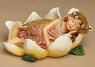1st Edition Boyds FaeriePetal Drema  Faierieslumber Bed of Petals - (introduced Spring 2004 and has been retired) Drema's drifted off to sleep and is dreaming sweetly! This precious angel nestles on a bed of petals and features iridescent sparkle wings and wears a garland of sparkling flowers.  Quote:"And if tonight my soul may find peace in sleep...and in the morning wake like a new-opened flower, then I have been dipped again in God." - D.H. Lawrence   4 inches long 3 inches deep 2 inches high