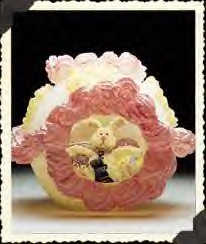 Boyds B Hopplewhite, Esquire Sugar Egg - (introduced Spring 2000 and has been retired) Outside, it's decorated in yellow and pink icing...Mmmm - but inside you'll find B. Hoppelwhite working hard at guarding his nest of eggs...although he looks mighty relaxed for a workin' Hare. (not a toy)