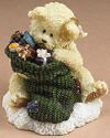2nd Edition Boyds Lil Wings Peek with Presents in Stocking - (introduced Spring 2006) This adorable angel bear named Peek is letting the Christmas curiosity get the better of him. It has lots of hand decorated details and a quote by Richard Wagner, "Joy is not in things, it is in us" adorning this adorable gift boxed figurine. 2 1/4 inches