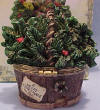 Back view of 2nd Edition Boyds Uncle Beans Treasure Box Nicholas Holiday Basket - (introduced Fall 2004 and has been retired) This rustic basket (looks like bark!) is filled with holiday greens. Pop the lid to read a special Christmas message and reveal a heart and holly tray. Remove the tray to find a little reindeer mouse-stuffed from eating too many sugar cookies! Inside the lid reads: "May Christmas be Evergreen in your heart." Quote: "God Bless Christmas" - Charles Dickens 2 1/2 inches high by 3 inches wide by 2 inches deep