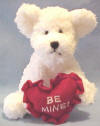 Boyds Bear Kisses White Teddy Bear - (introduced in 2002 and has been retired) &nbsp;This EXTREMELY SOFT AND CUDDLY White Bear is made from the new materials which makes it hard to leave alone!  It is holding a red heart shaped pillow with 'Be Mine!' embroidered on it in white.  It is limited to Valentines Day 2003.  (safe for ages over 3)  8 inches