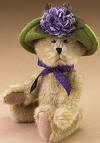 Boyds Lilac LeFleur Teddy Bear in Green Hat with Purple Flower- (introduced Spring 2005 and has been retired) Lilac LeFleur is all ready for the garden tea party! This gold bear features a green hat with a purple flower.  (safe for ages over 3)  6 inches and poseable