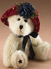 Boyds Dolly Teddy Bear in a Burgundy Hat with a Flower and Blue Star on Foot - (introduced Fall 2005)  Hats and such girls go Americana! Dolly is an off white, poly filled bear in a burgundy hat, blue neck bow and star paw pad embroidery.  6 inches and poseable