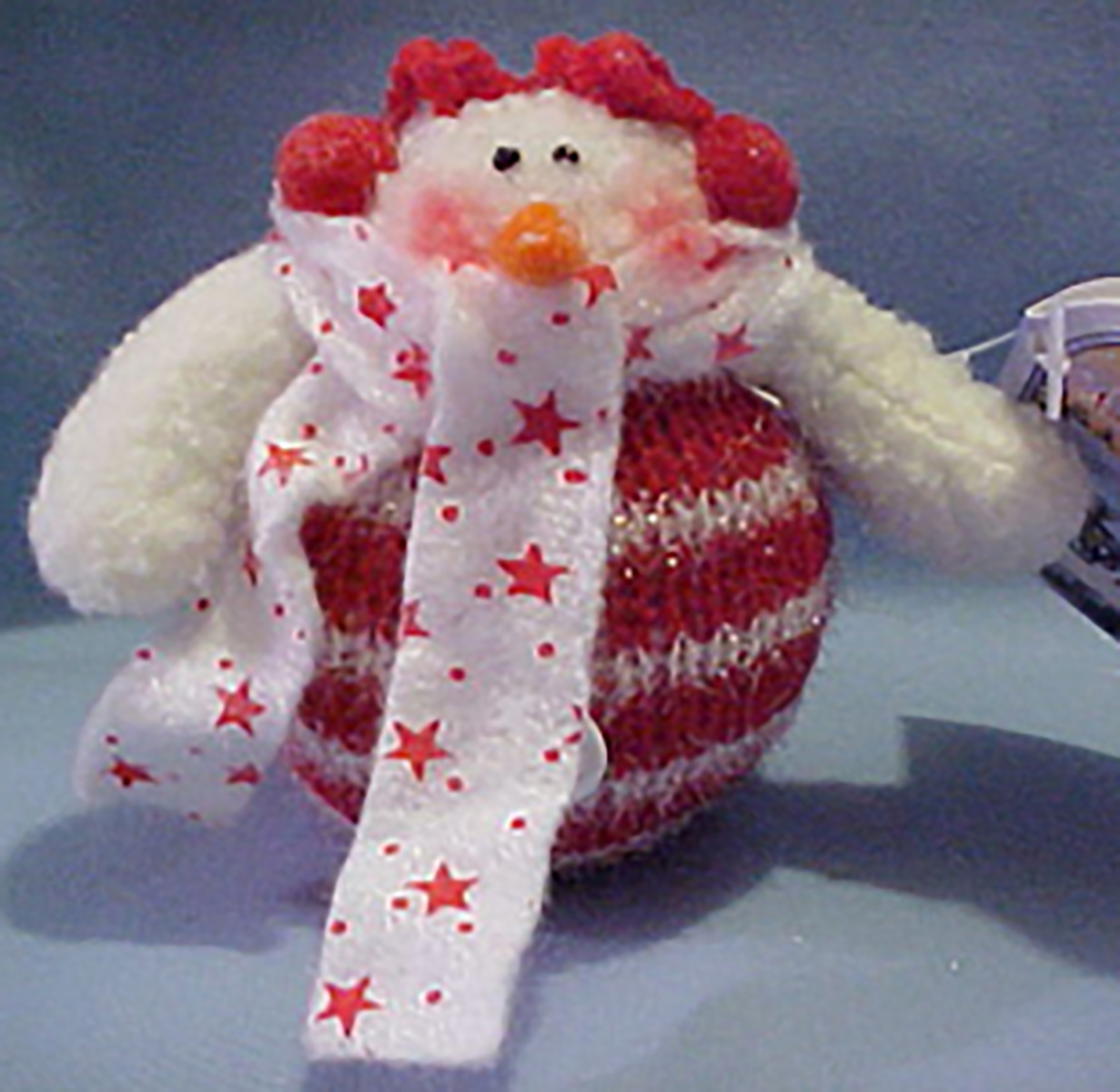 Candy Cane Snowman with Red Ear Muffs and Star Scarf Christmas Ornament Candy Cane Snowman with Red Ear Muffs and Star Scarf Christmas Ornament
- It has a gift card which has "To:" and "From:".
- The card also reads: "Gentle as snowflakes, Holiday Memories, Drift into the heart and lead us home."