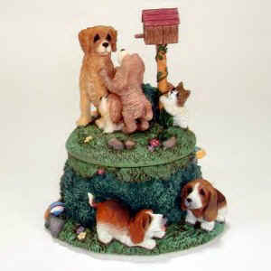Lou Rankin's musical figurines have many puppies playing on top and around the music box.