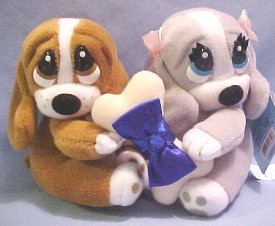 The always adorable Sad Sam and Honey Basset Hounds hold a birthstone gem on a dog bone between them representing each month of the year.