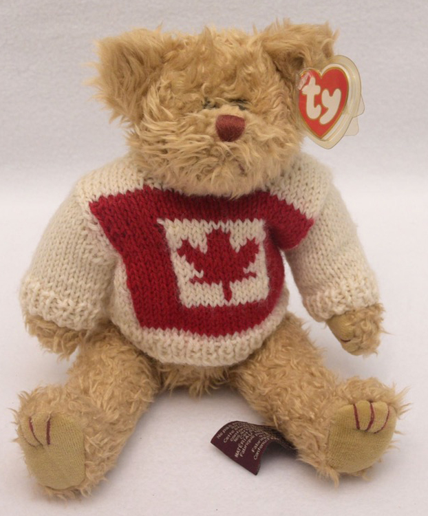 TY Attic Treasures Mackenzie Canadian Teddy Bear TY Attic Treasures Mackenzie Canadian Teddy Bear
- introduced in the Fall 1998 and retired on 5/27/00
- Fully jointed plush tan teddy bear
- She is wearing a creamy white sweater with a Maple Leaf on the front
- Designed by Ty Warner